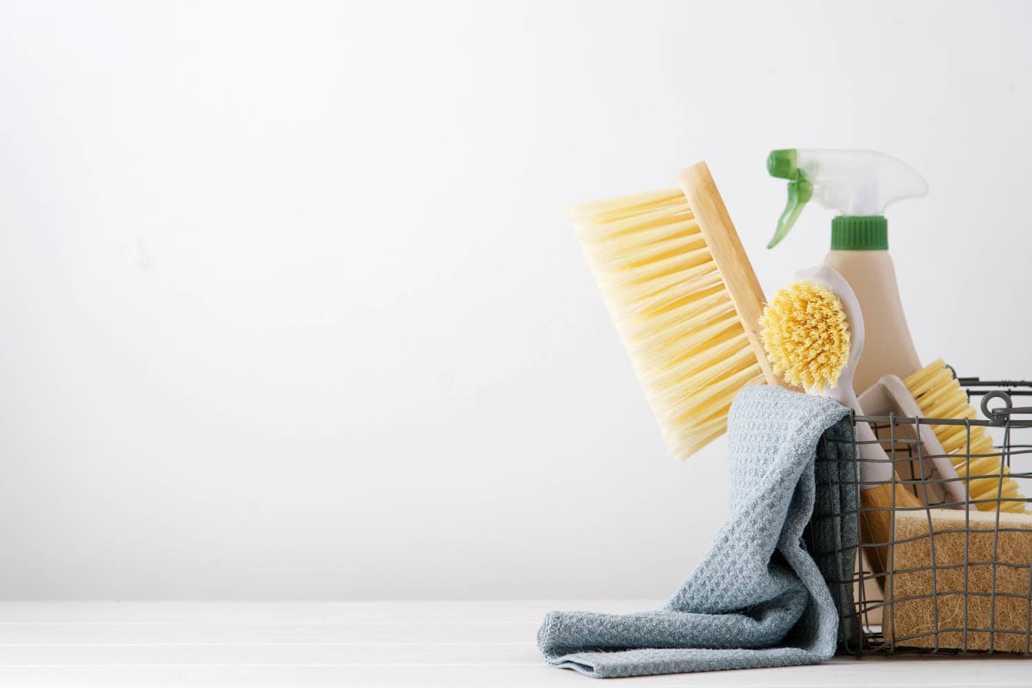 Eco brushes, sponges and rag in cleaning basket. Cleaner concept